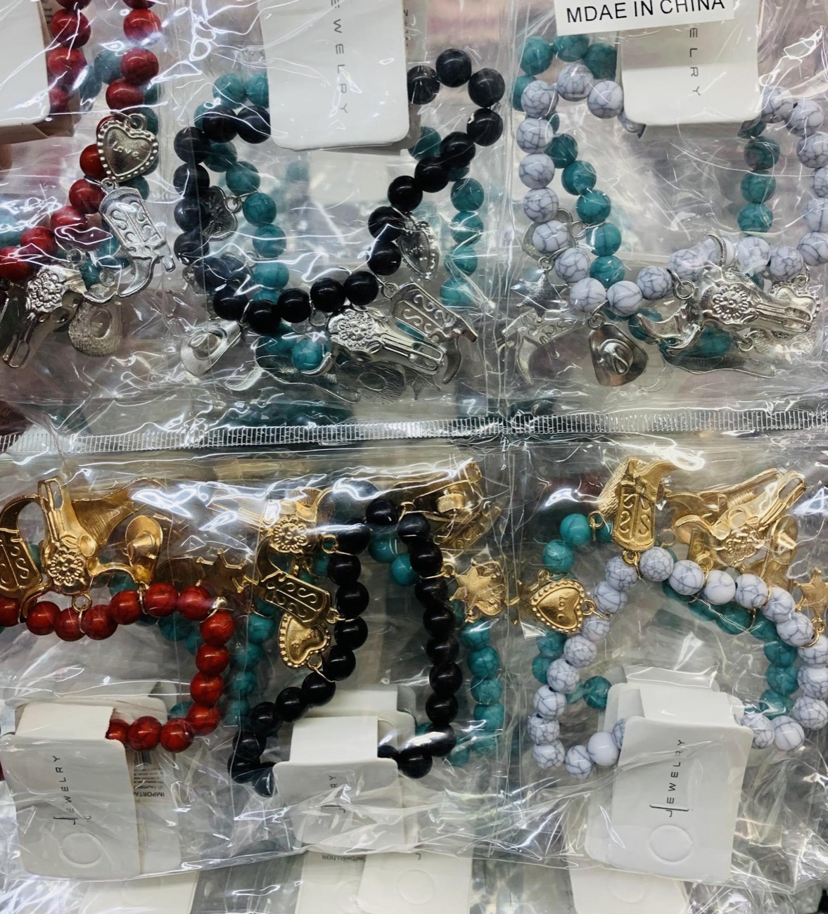 Beaded bracelets with charms in red, black, teal and white
