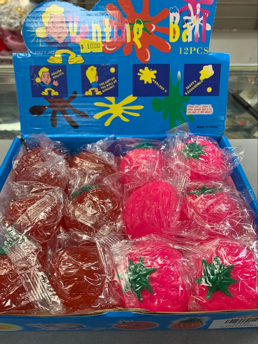 Pink strawberry squeeze balls in a display box